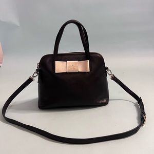 Black Kate Spade purse with small white bow and gold accents